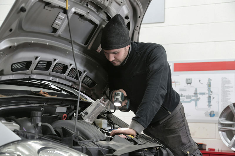 Mechanic inspecting a car engine