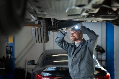 Man checking car and installing fog lights