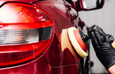 Close up of person cleaning car fender