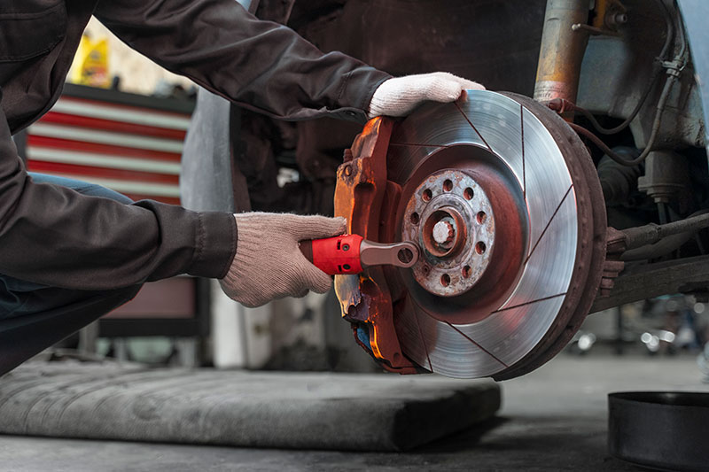 Worker repairing car brakes